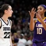 LSU's Angel Reese reacts in front of Iowa's Caitlin Clark during the second half of the NCAA Women's Final Four championship basketball game Sunday, April 2, 2023, in Dallas. LSU won 102-85 to win the championship. (AP Photo/Tony Gutierrez)