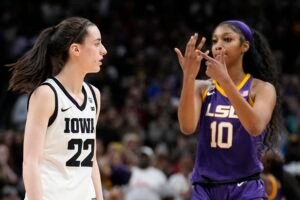 LSU's Angel Reese reacts in front of Iowa's Caitlin Clark during the second half of the NCAA Women's Final Four championship basketball game Sunday, April 2, 2023, in Dallas. LSU won 102-85 to win the championship. (AP Photo/Tony Gutierrez)